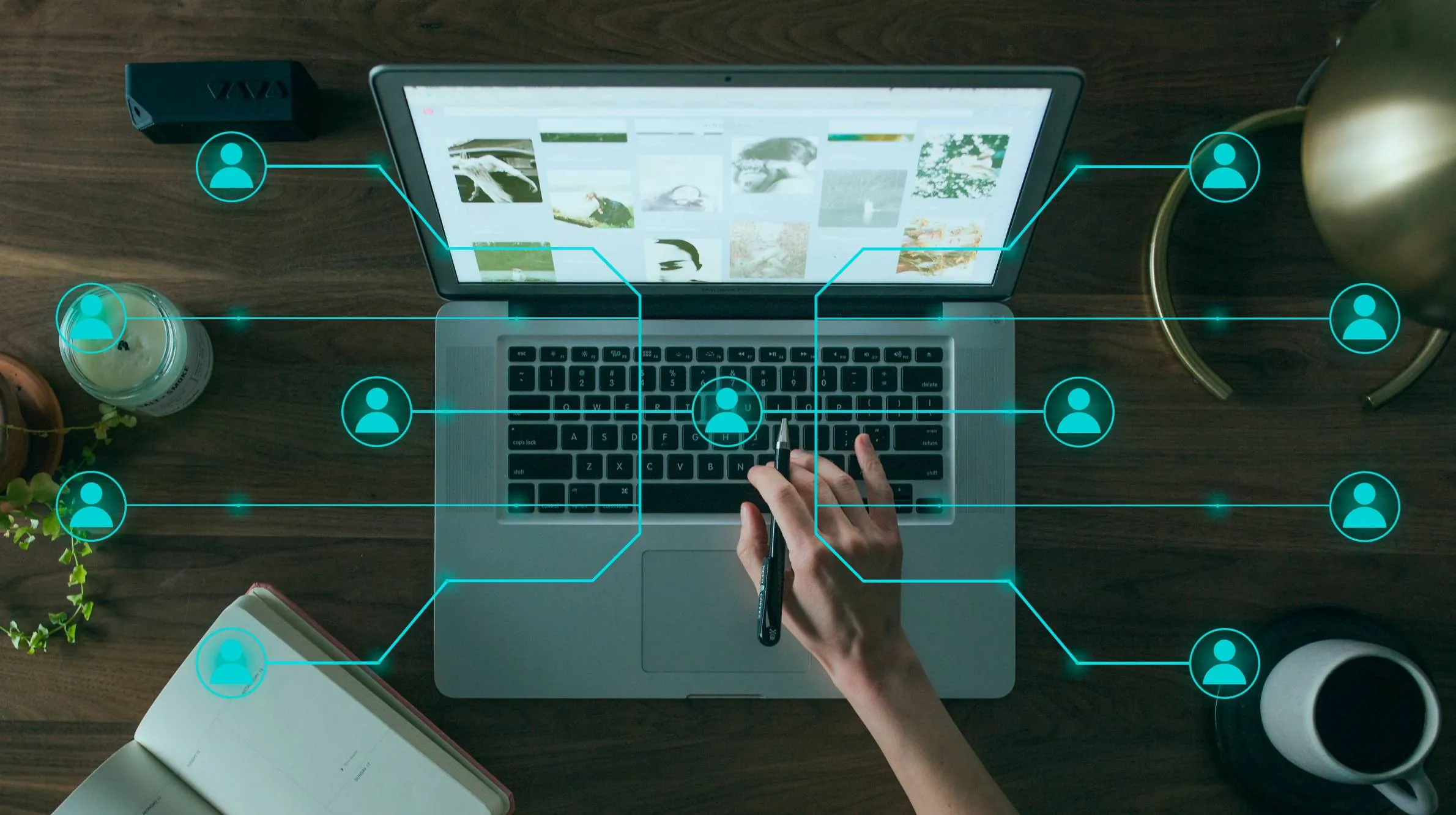 Laptop on a desk with connected people icons, representing a team and its network